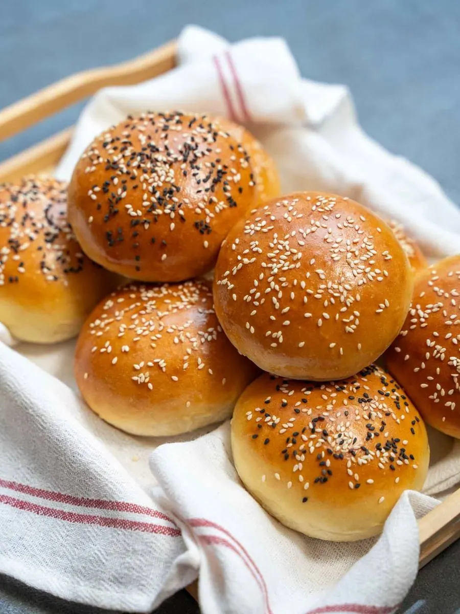 Freshly baked sesame rolls, showing the texture you'll learn to achieve